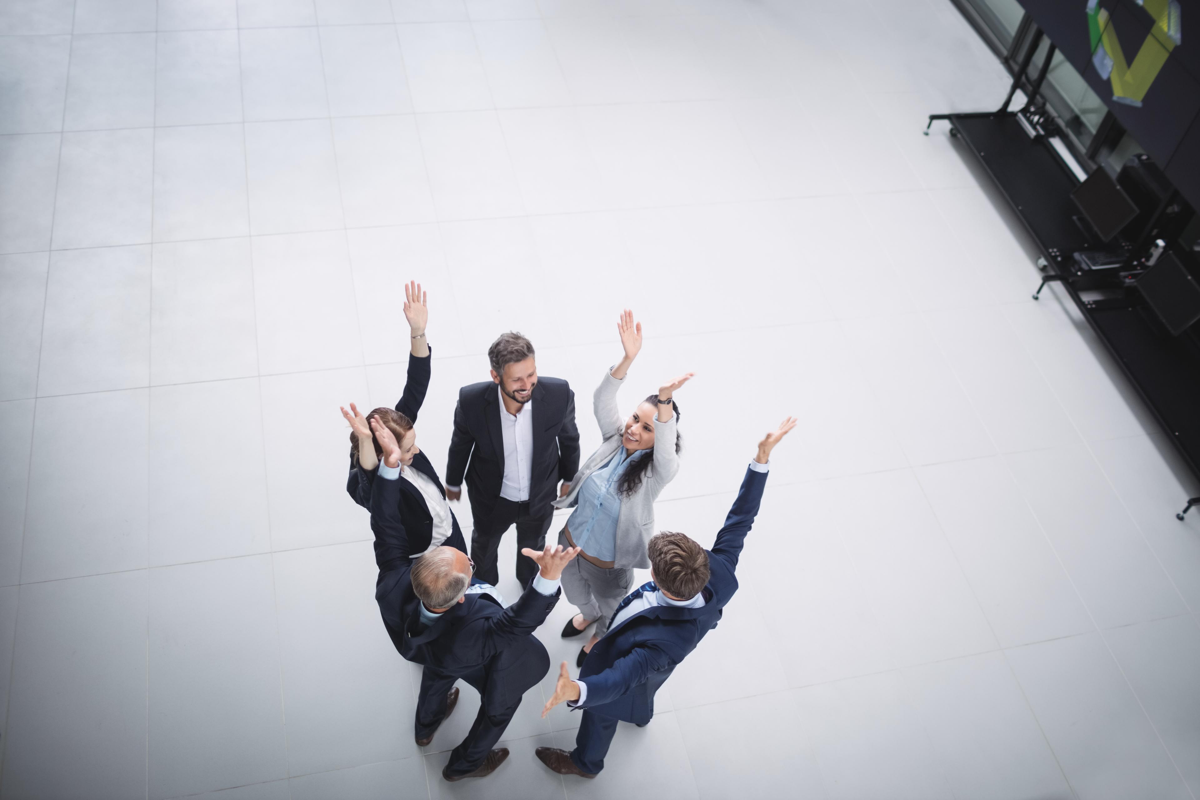 businesspeople-standing-with-hands-raised.jpg